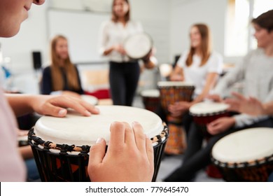 Teenage Students Studying Percussion In Music Class