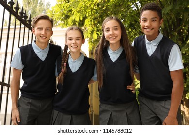 Teenage Students In Stylish School Uniform Outdoors