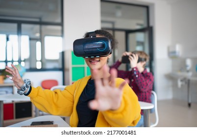 Teenage students wearing virtual reality goggles at school in computer science class - Powered by Shutterstock