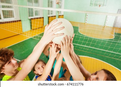 Teenage Volleyball Team Players Serving A Ball