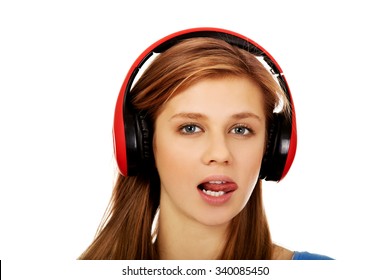 Teenage Woman Listens To Music And Shows Tounge.