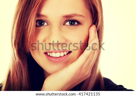Teenage woman smiling in cheerful mood