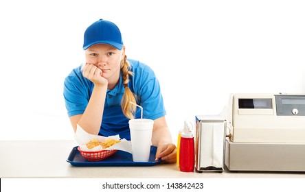 Teenage worker in a fast food restaurant bored and leaning on the counter.  White background. - Powered by Shutterstock