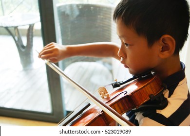 Teenager Asian Boy Playing The Violin