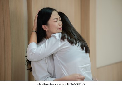 Teenager Asian Woman Embracing  Her Mother And Crying After Receiving Bad News At Hospital. Two Women Crying And Grieving While Waiting For Doctor In Front Of ICU Or Emergency Room.