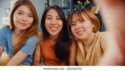 Teenager Asian Women Feeling Happy Smiling Selfie And Looking To Camera While Relax In Living Room At Home. Cheerful Roommate Ladies Video Call With Friend And Family, Lifestyle Woman At Home Concept.