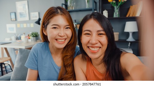 Teenager Asian Women Feeling Happy Smiling Selfie And Looking To Camera While Relax In Living Room At Home. Cheerful Roommate Ladies Video Call With Friend And Family, Lifestyle Woman At Home Concept.