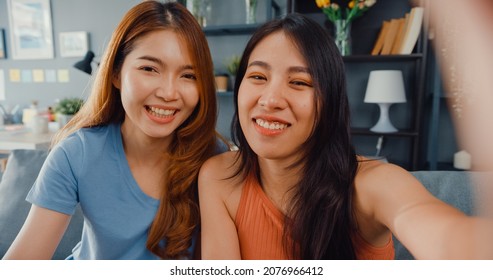 Teenager Asian Women Feeling Happy Smiling Selfie And Looking To Camera While Relax In Living Room At Home. Cheerful Roommate Ladies Video Call With Friend And Family, Lifestyle Woman At Home Concept.