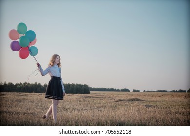 teenager balloons in summer field
