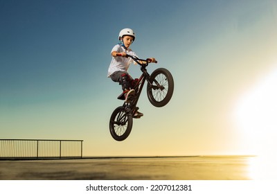 A teenager BMX Racing Rider performs tricks in a skate park on a pump track. - Powered by Shutterstock