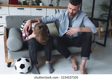 Teenager Boy With A Backpack Disappointed And Sad Because Of Football Game. Dad Supporting Him. Back To School Concept. Cute Brown Pet Dog Around. 