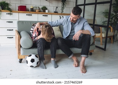 Teenager Boy With A Backpack Disappointed And Sad Because Of Football Game. Dad Supporting Him. Back To School Concept. Cute Brown Pet Dog Around. 