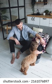 Teenager Boy With A Backpack Disappointed And Sad Because Of Football Game. Dad Supporting Him. Back To School Concept. Cute Brown Pet Dog Around. 
