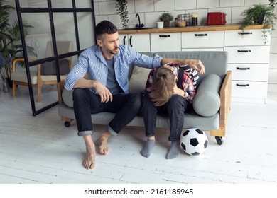 Teenager Boy With A Backpack Disappointed And Sad Because Of Football Game. Dad Supporting Him. Back To School Concept. Cute Brown Pet Dog Around. 