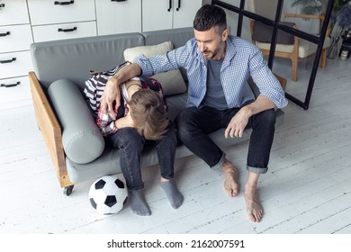 Teenager Boy With A Backpack Disappointed And Sad Because Of Football Game. Dad Supporting Him. Back To School Concept. Cute Brown Pet Dog Around. 