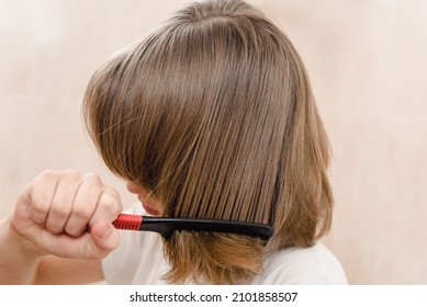 Teenager Boy Brushing Hair With Comb At Home Bathroom