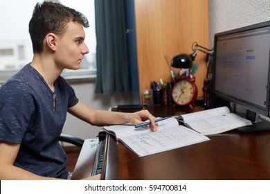 Teenager Boy Doing Homework At His Computer