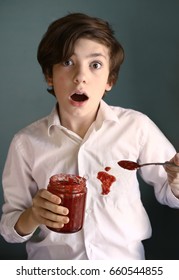 Teenager Boy With Fear Expression Hold Jam Bar Teaspoon Has A Spot On White Shirt