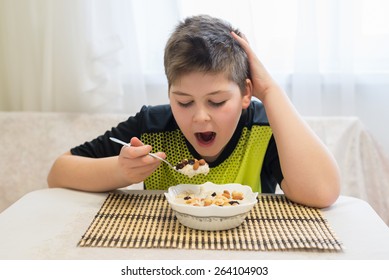 Teenager Boy Has Oatmeal For A  Breakfast