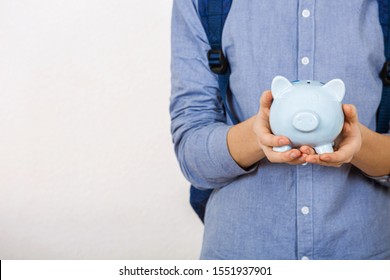 Teenager Boy Holding Piggy Bank Over White Background.
Financial Education Savings Concept