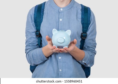 Teenager Boy Holding Piggy Bank Over White Background.
Financial Education Savings Concept