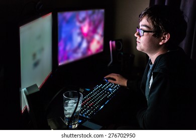 Teenager Boy On Computer In His Room Late At Night.