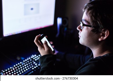 Teenager Boy On Computer In His Room Late At Night.