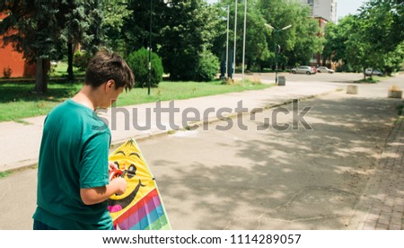 Similar – Young man riding on skate and holding surfboard