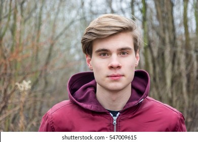 Teenager Boy Portrait In Winter Nature, Closeup Face Looking Straight Into Camera