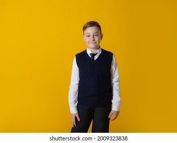 
Teenager boy in a school uniform with stands on a yellow background and smiles. School, training, September 1st. - Shutterstock ID 2009323838