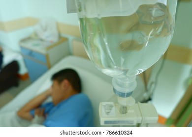 Teenager Boy Was Sick And Sleep With Equipment IV Tube Of Infusion Pump At Hospital,selective Focus And Space