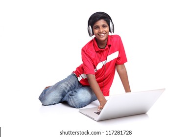 Teenager Boy Is Sitting With Laptop On White Background.