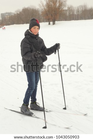 teenager boy skiing in the winter park
