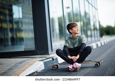 Teenager boy in a sports suit with longboard. - Powered by Shutterstock