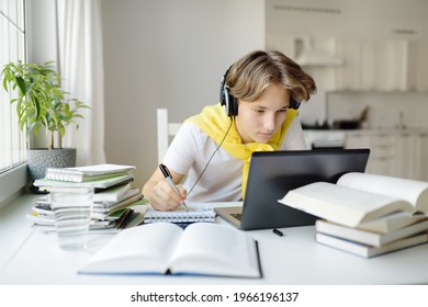 Teenager Boy Study At Home. Online Education And Distance Learning For Children. School Boy Doing His Physics Homework Using Gadgets. Lectures And Lessons On The Internet For High School Students