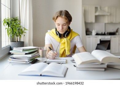 Teenager Boy Study At Home. Online Education And Distance Learning For Children. School Boy Doing His Physics Homework Using Gadgets. Lectures And Lessons On The Internet For High School Students