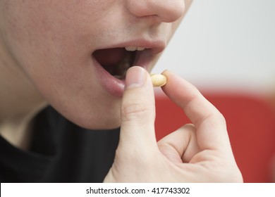 The Teenager Boy Take Vitamin C Pill