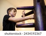 teenager boy training with Winchun wooden dummy, 11 year old child training wushu, Yunchunquan style, Winchun.