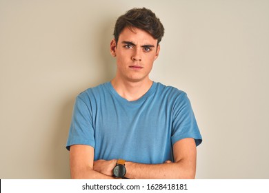 Teenager Boy Wearing Casual T-shirt Standing Over Isolated Background Skeptic And Nervous, Disapproving Expression On Face With Crossed Arms. Negative Person.