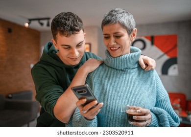 teenager boy young man and mature woman mother and son take selfie photos self portraits at home - Powered by Shutterstock