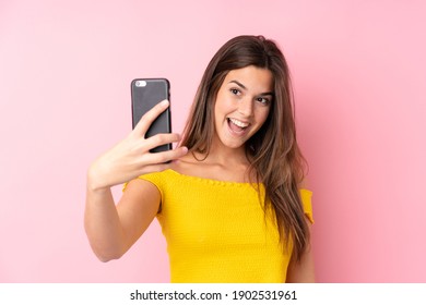 Teenager Brazilian girl over isolated pink background making a selfie - Shutterstock ID 1902531961