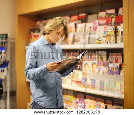 Teenager  buying a magazin in a store