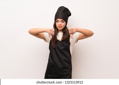 Teenager Chef  Over White Wall Showing Thumb Down