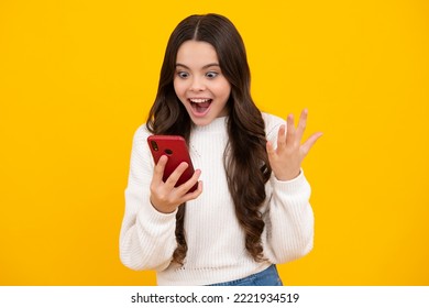 Teenager Child Girl Holding Smartphone. Hipster Girl With Cell Phone. Kid Hold Mobile Phone Texting In Online Social Networks. Excited Teenager Girl.