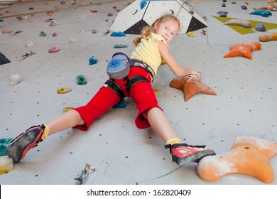 Teenager Climbing A Rock Wall