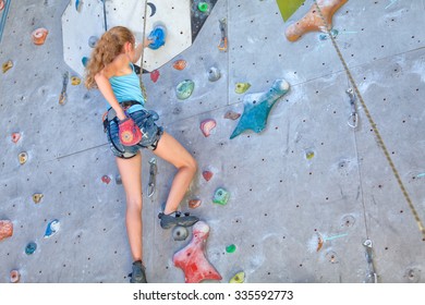 Teenager Climbing A Rock Wall Indoor