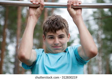 The Teenager Doing Exercise On A Horizontal Bar