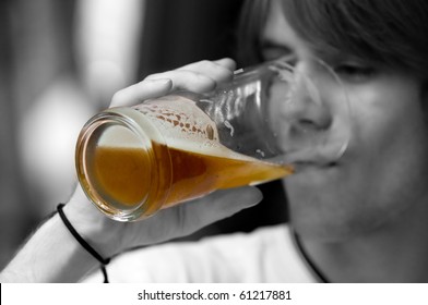 Teenager drinking beer. Black and white