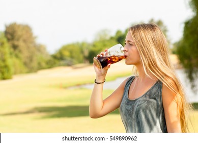 Teenager Drinking A Glass Of Soda