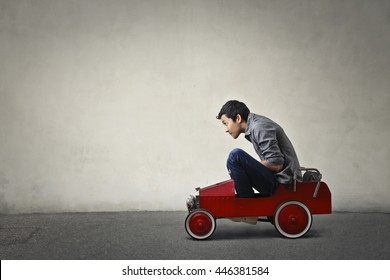 Teenager Driving A Toy Car